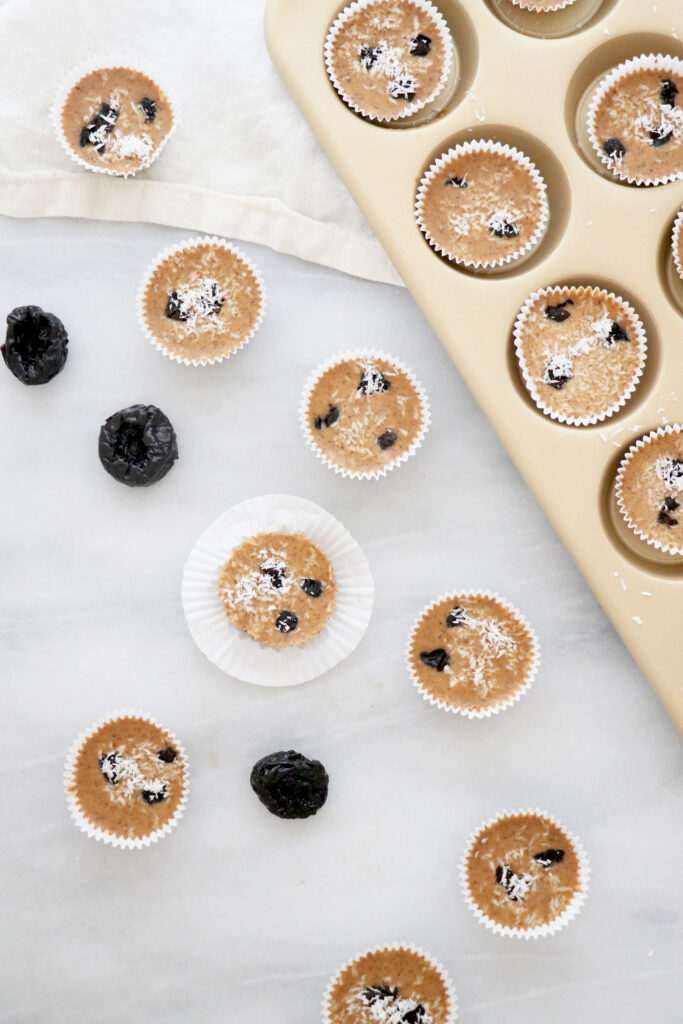 Almond butter prune cups in muffin pan as well as on the side.