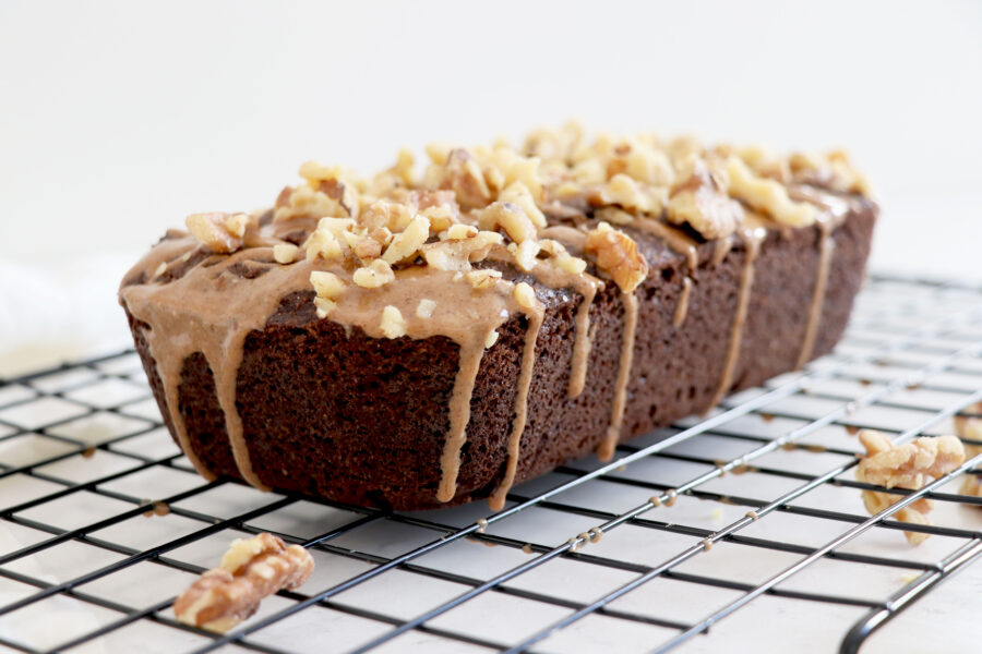 Loaf of cacao bread on top of wire rack.