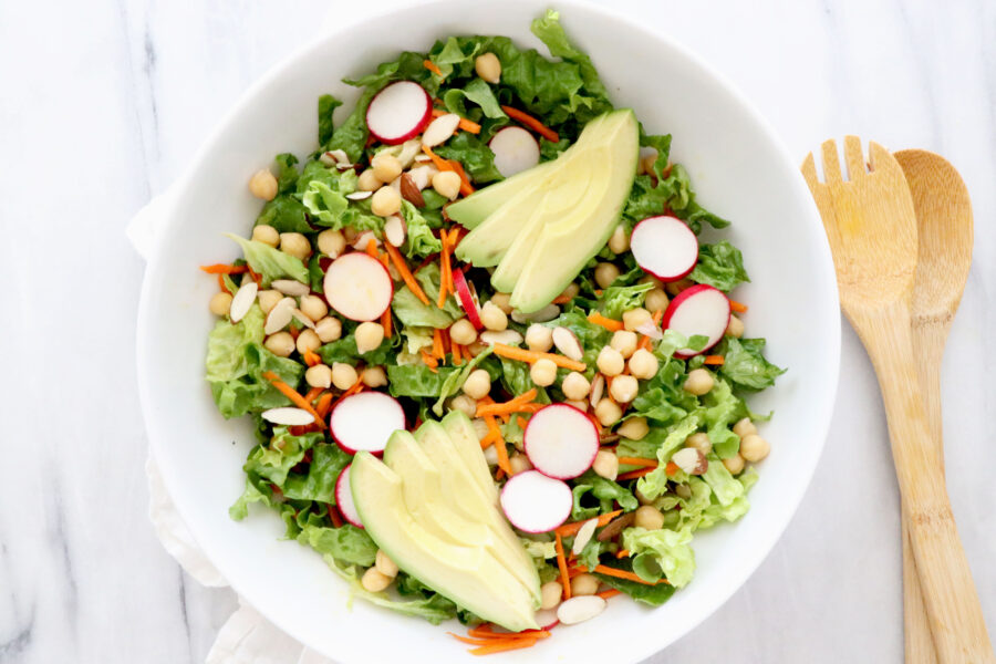 Salad bowl in center. Utensils on the right side.