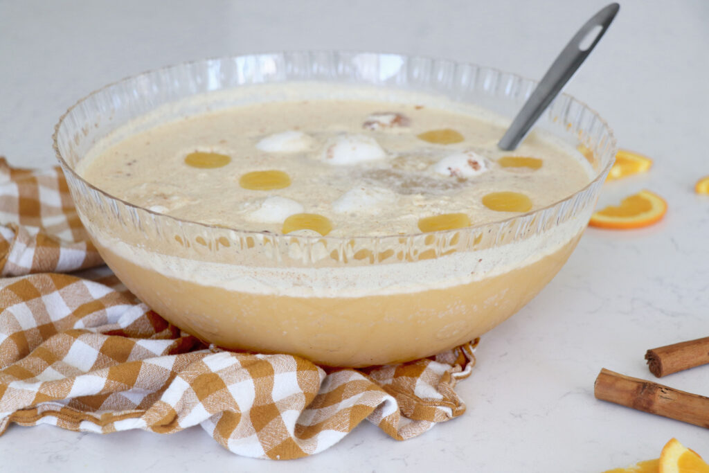 Punch bowl of fizzy drink with ladle in the bowl.