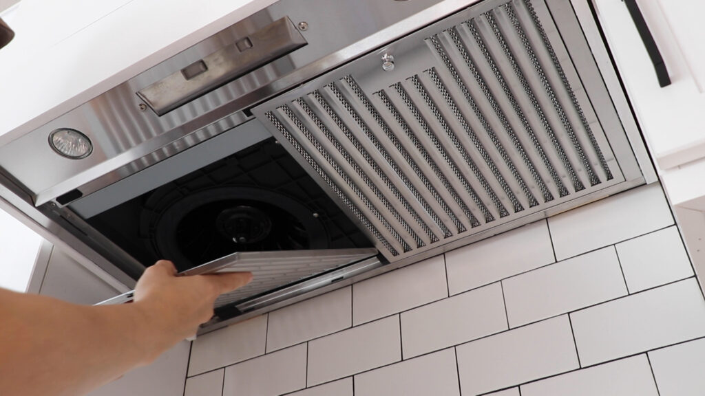 Filter grate being installed in new range hood fan