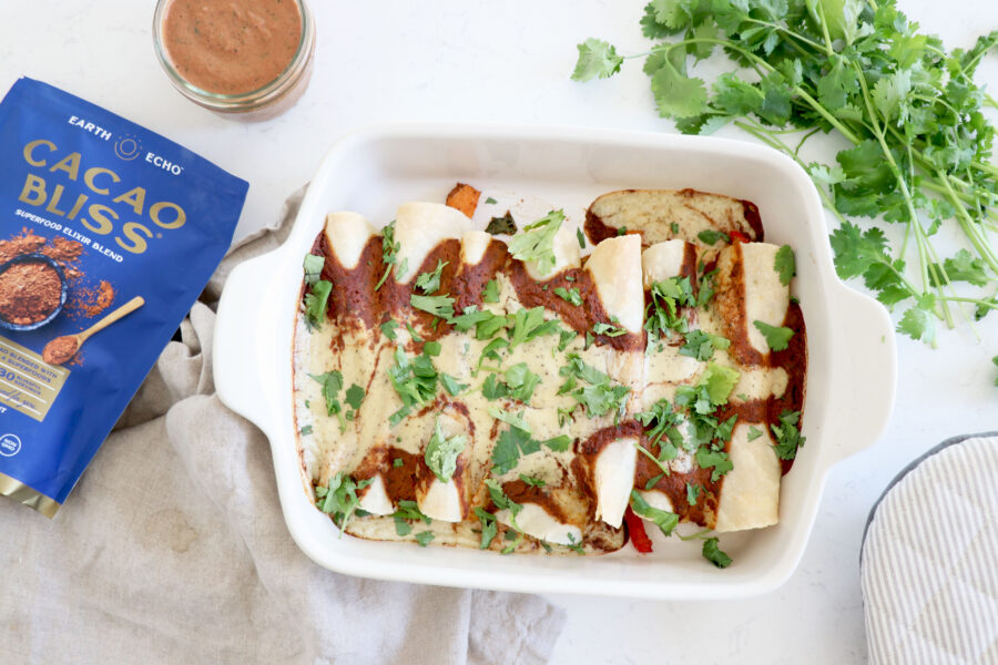 Enchiladas topped with mole sauce.