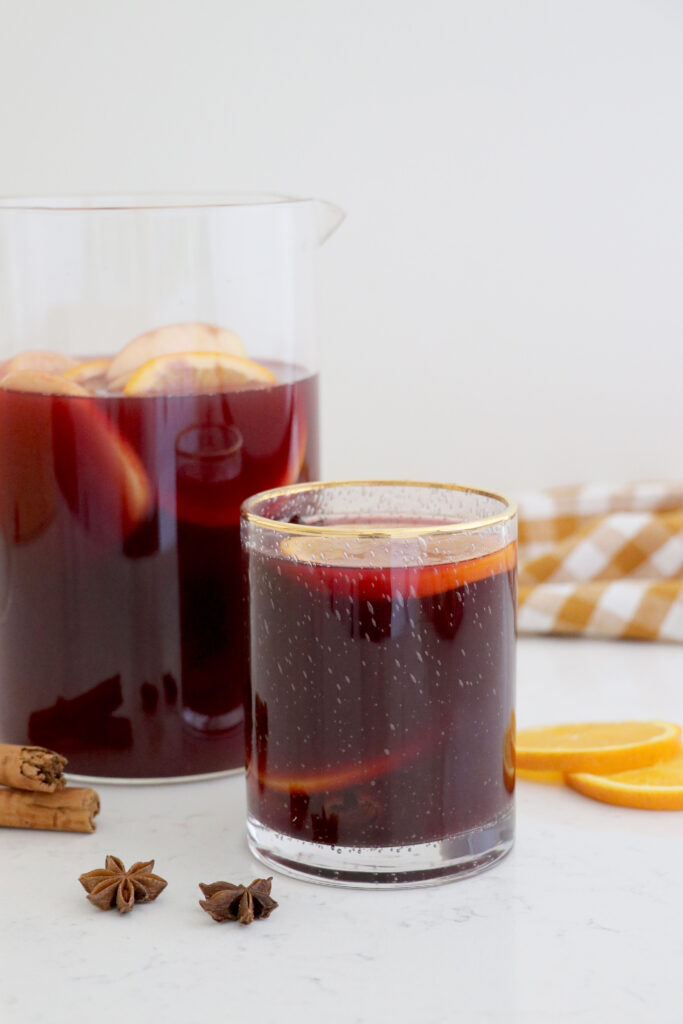 Sangria in glass and in glass pitcher. 