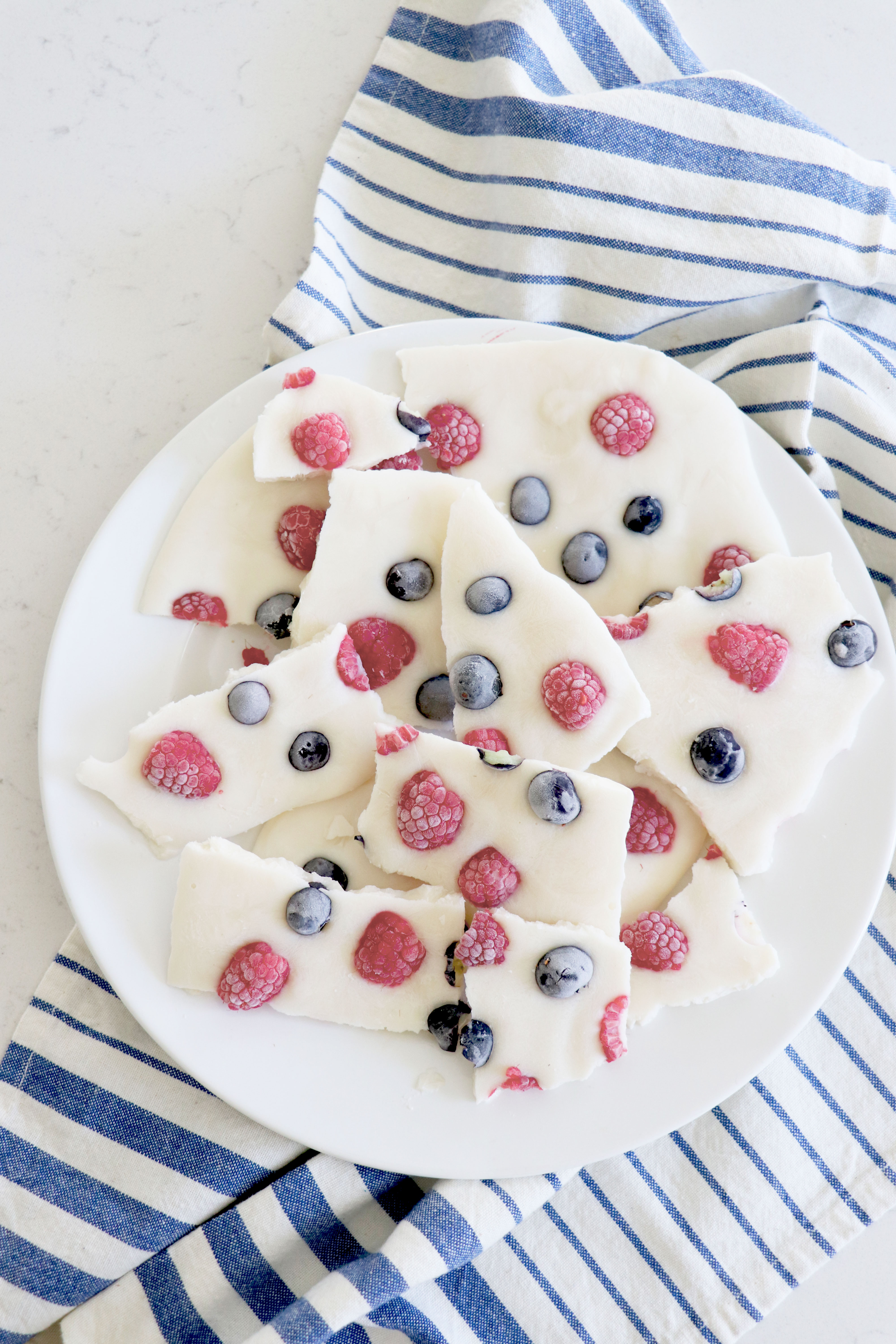 White yogurt bark with fruit on plate