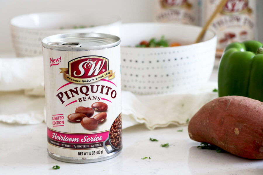 Can of chili beans with bowl of chili behind it.