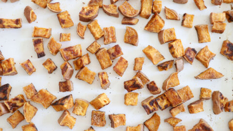 Roasted sweet potatoes on a white baking sheet