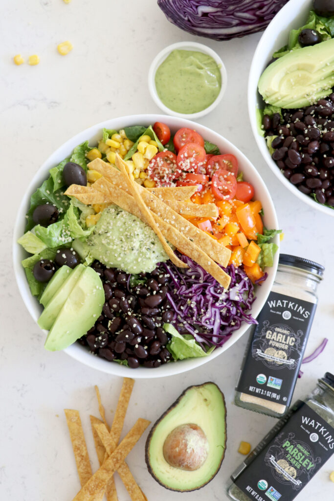 Bowls with taco salad and Watkin's seasoning on the side.