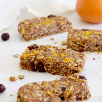 Four snack bars with orange in the background